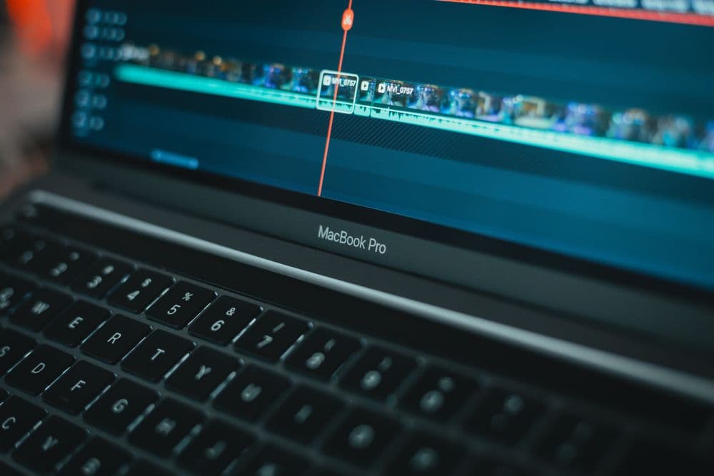 A laptop showing a video editing timeline