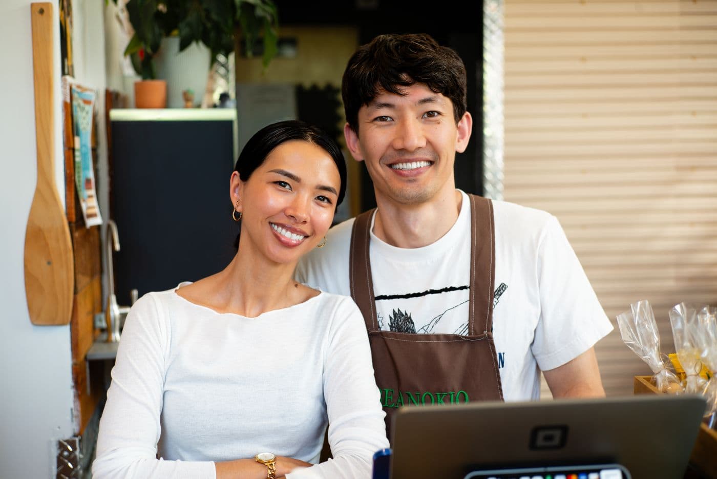 Two café owners behind their counter