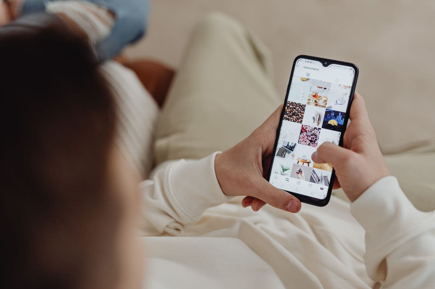 A person scrolling Instagram on a smartphone