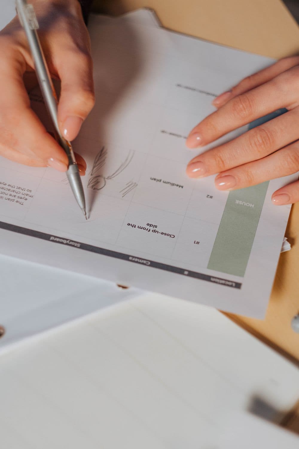 Artist sketching scene frames on a storyboard sheet